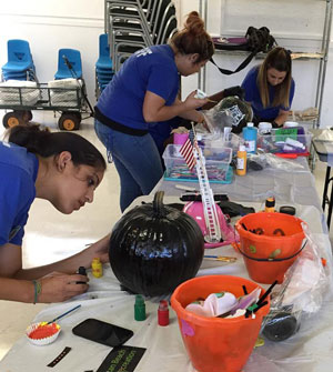 Parks and Recreation staff decorating pumpkins