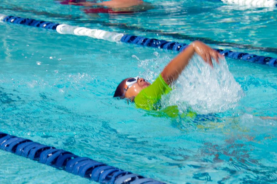 Boy doing backstroke during swim lesson