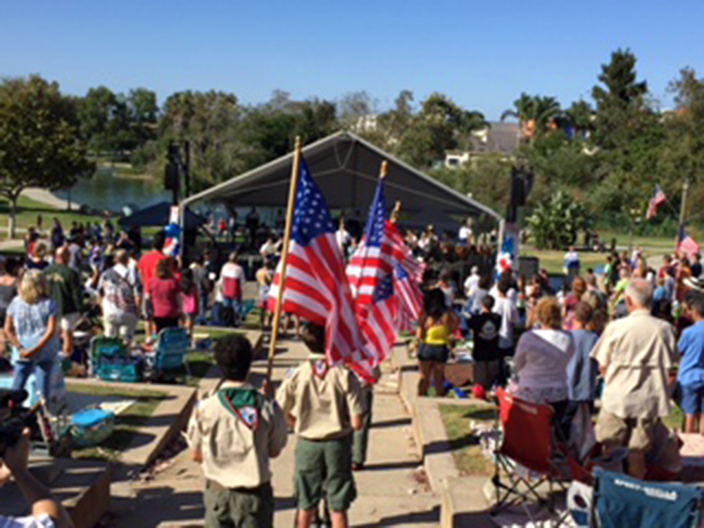 Local boy scout troops walking in American flags during National Anthem.